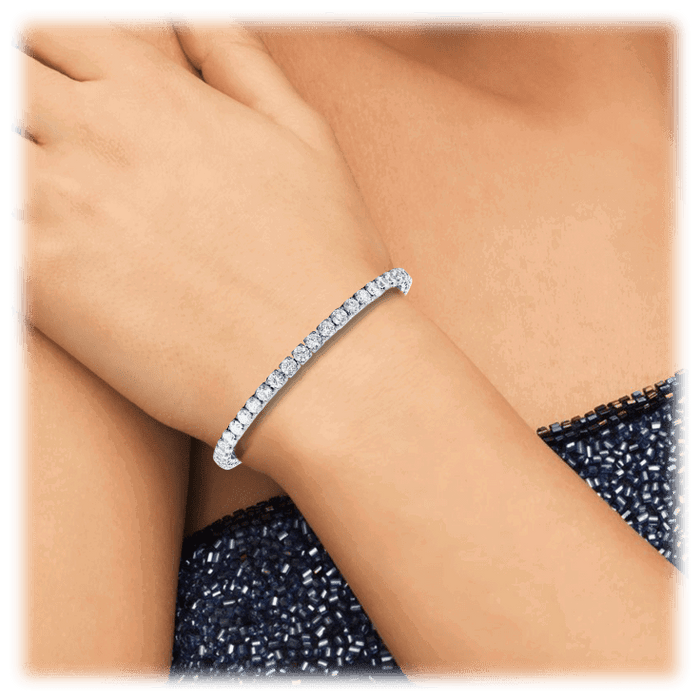 Silver cubic zirconia tennis bracelet with a slim row of round stones on wrist.