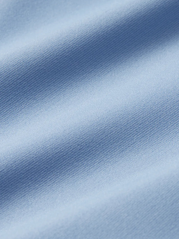 Swatch of light blue anchor rashguard fabric.