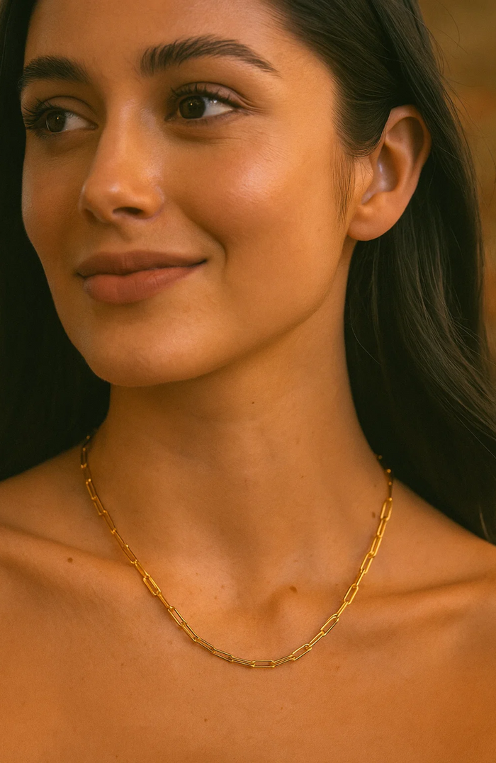 Gold paperclip-link necklace on model, connected link chain at neckline