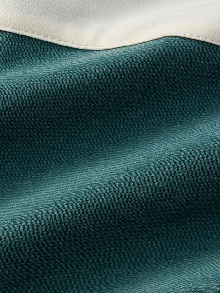 Close-up of teal fabric with a white border