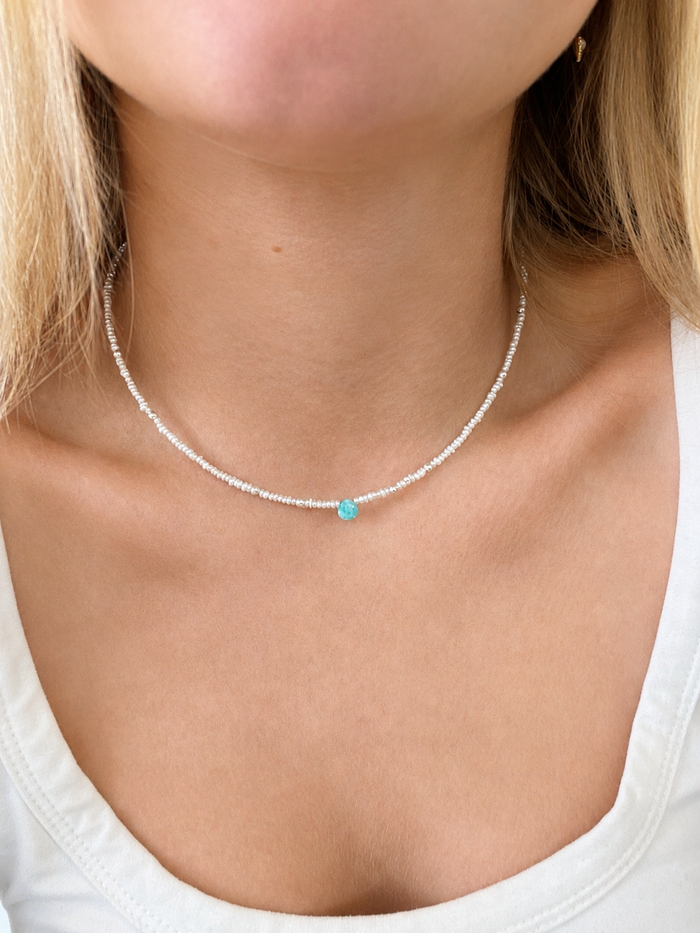 Beach Bliss Pearl Larimar Necklace Silver featuring delicate white pearl beads and a turquoise larimar centre stone, worn on the neck.