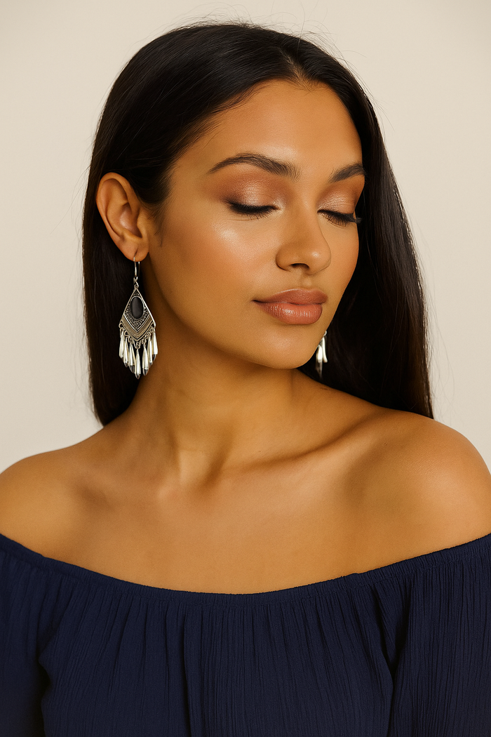 Teardrop silver fringe earrings with dark cat-eye center, worn on model