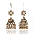 Boho drop earrings with ornate filigree, round studs, and bell-like tassel details