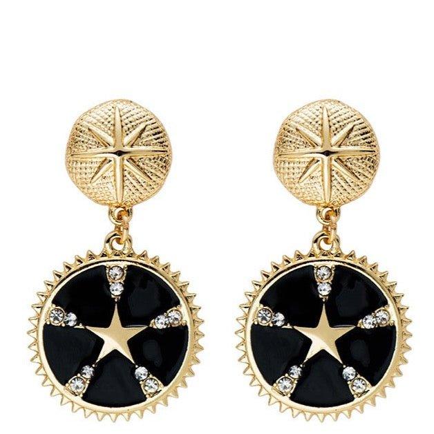 Gold-tone star dangle earrings with black enamel round drops and crystal accents