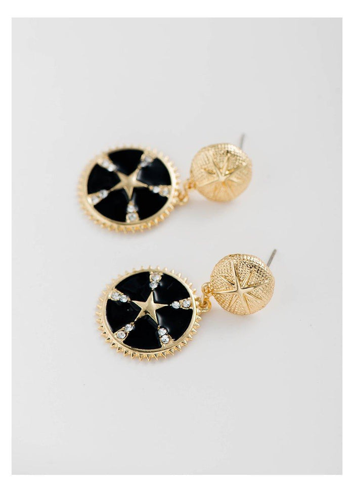 Gold-tone star dangle earrings with black enamel round drops, crystal accents, gold back