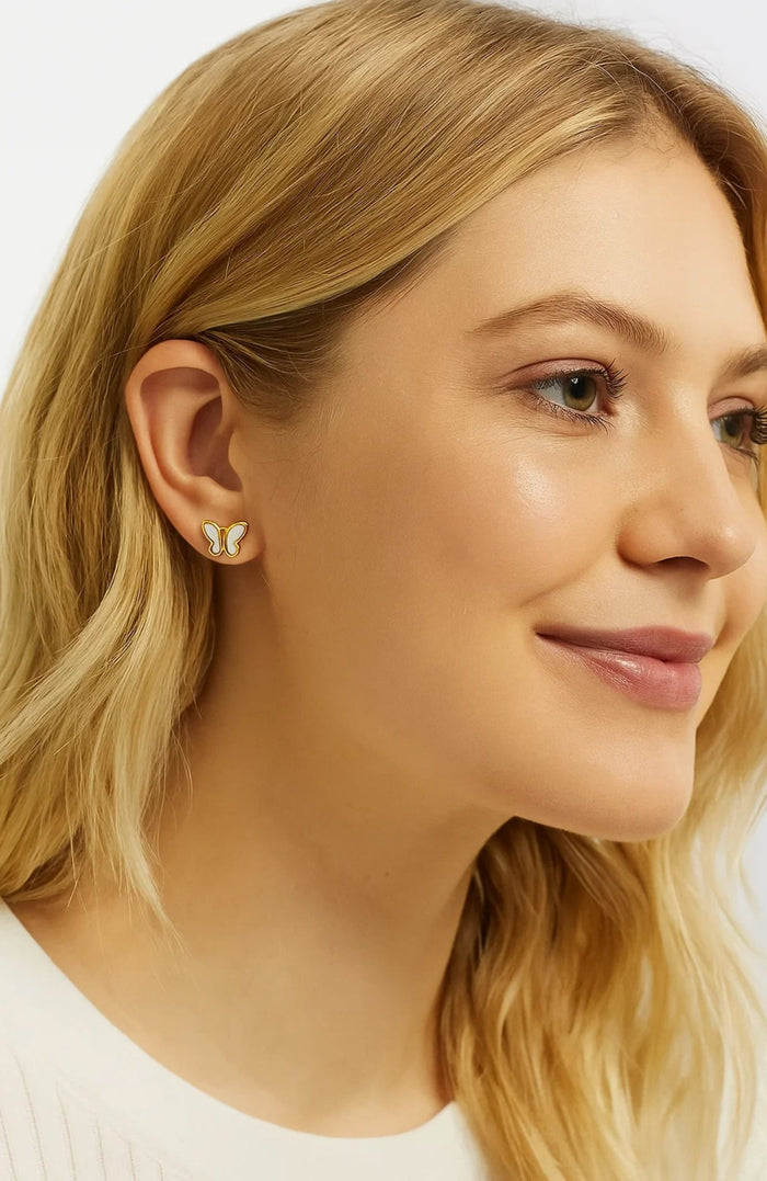 Gold butterfly stud earrings with mother-of-pearl inlay, small side profile ear detail
