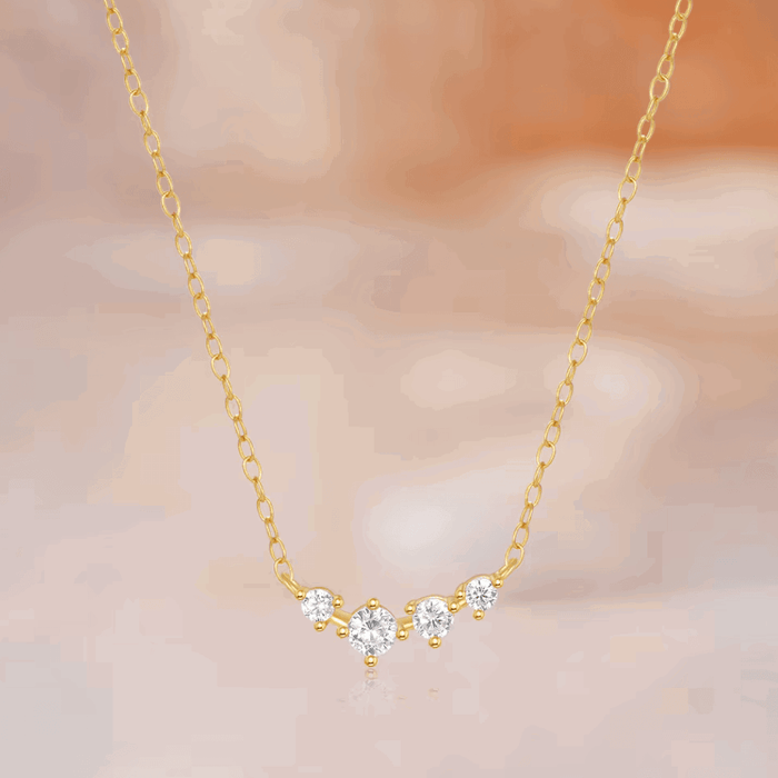 Gold-tone chain necklace with central star-shaped clear stone cluster