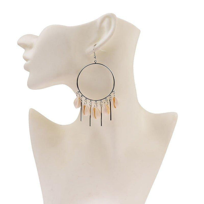 Silver hoop chandelier earrings with peach puka seashell fringe on mannequin bust