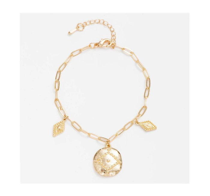 Gold coin charm bracelet with round coin charm and two leaf charms on chain