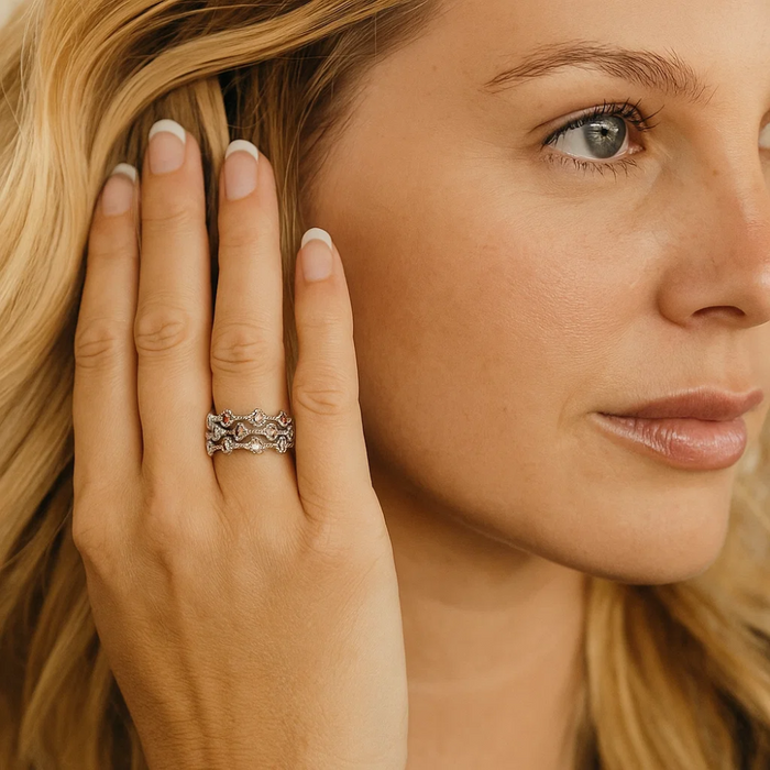 Silver-tone multicolor cubic zirconia ring on hand, ornate band with small round stones