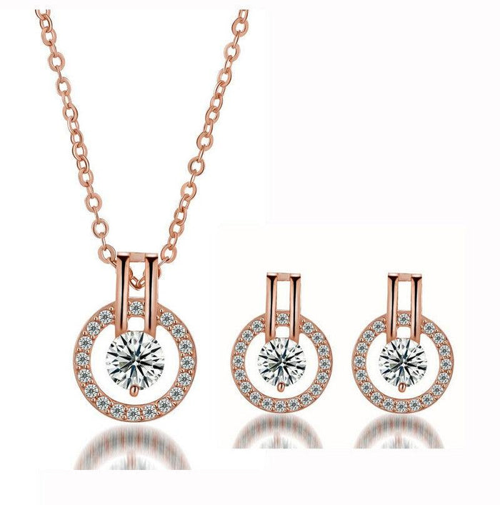Rose gold cubic zirconia necklace with round halo pendant and stud earring set