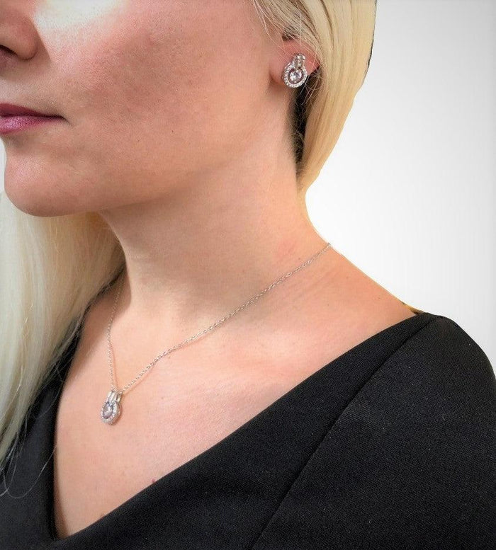 Silver-tone cubic zirconia stud earring and pendant necklace on model