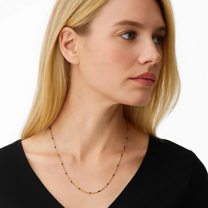 Gold beaded link necklace with dark onyx stones, fine chain and small beads.