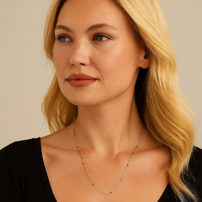Silver beaded link onyx necklace, delicate chain and small dark bead accents.
