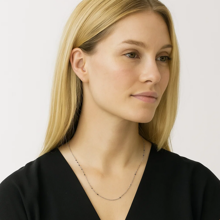 Silver beaded link necklace with dark onyx stones, slim chain with evenly spaced beads.