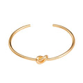Gold love-knot bangle bracelet with round twist knot detail