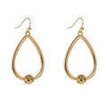 Gold teardrop hoop earrings with small love-knot detail at the bottom