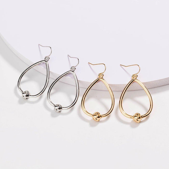 Mixed set of teardrop hoop earrings in silver and gold with love-knot charms