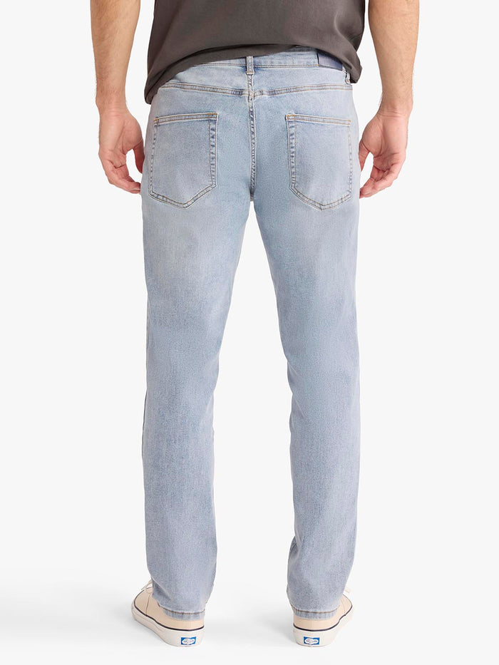 Light blue jeans worn by a person on a white background
