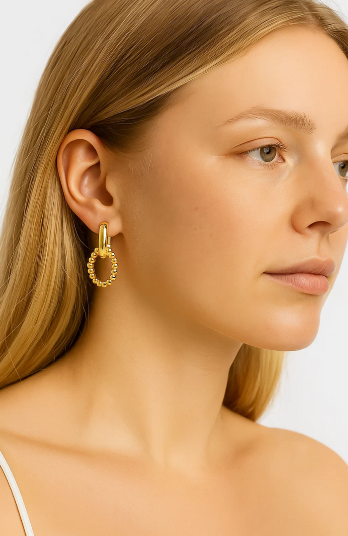 Gold link drop earrings with beaded oval hoop and small open link accent.