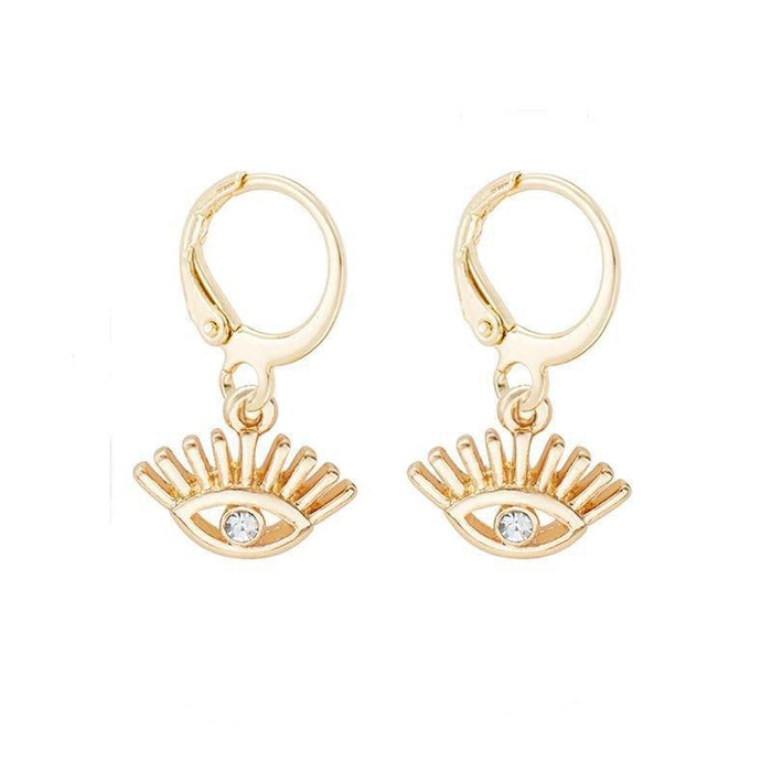 Gold-tone huggie hoop earrings with dangling evil-eye charm and blue crystal
