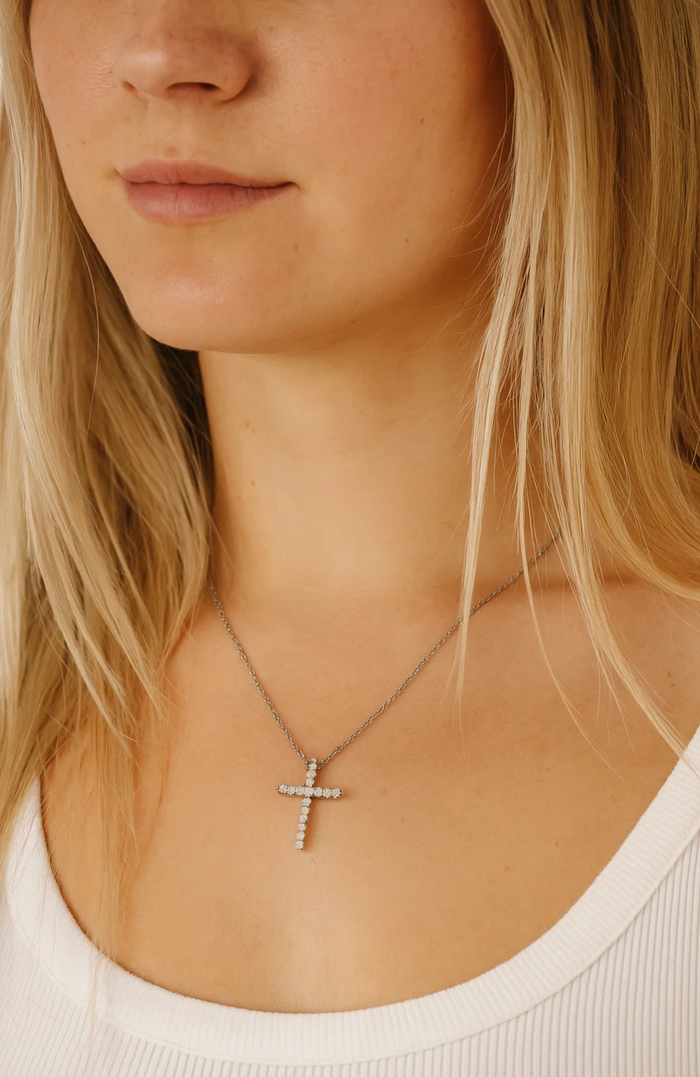 Cubic zirconia cross pendant necklace close to the collarbone