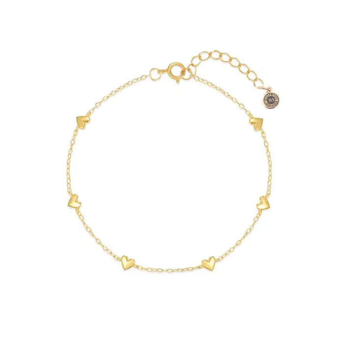 Gold heart charm bracelet with small heart links and secure clasp