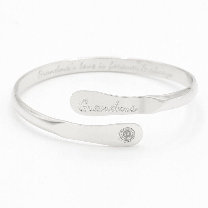 Silver-toned cuff bracelet with engraved “Grandma” and round charm detail