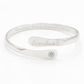 Silver-toned cuff bracelet with engraved “Grandma” and round charm detail