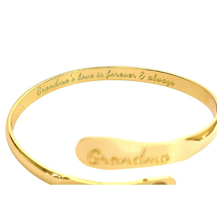 Gold-toned cuff bracelet with “Grandma” engraving along the outer edge