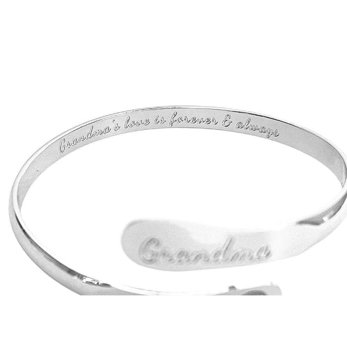 Silver-toned cuff bracelet with “Grandma” engraving along the outer edge