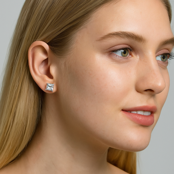 Single princess-cut cubic zirconia stud earring on ear, clear square stone