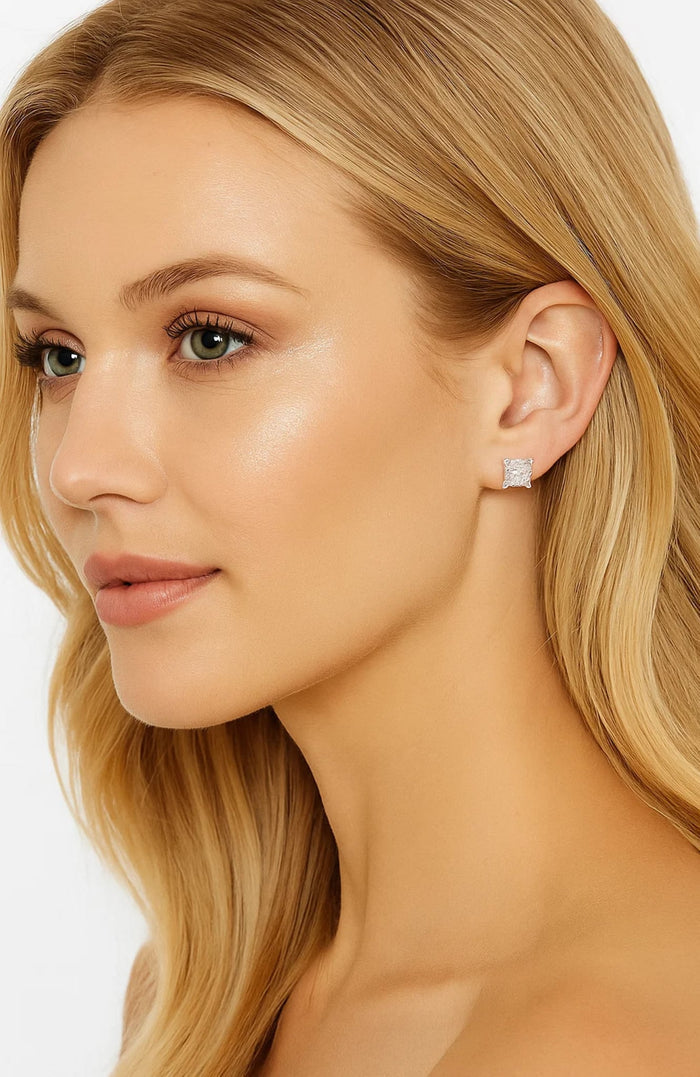 Model side profile wearing princess-cut cubic zirconia stud earrings, square clear stones