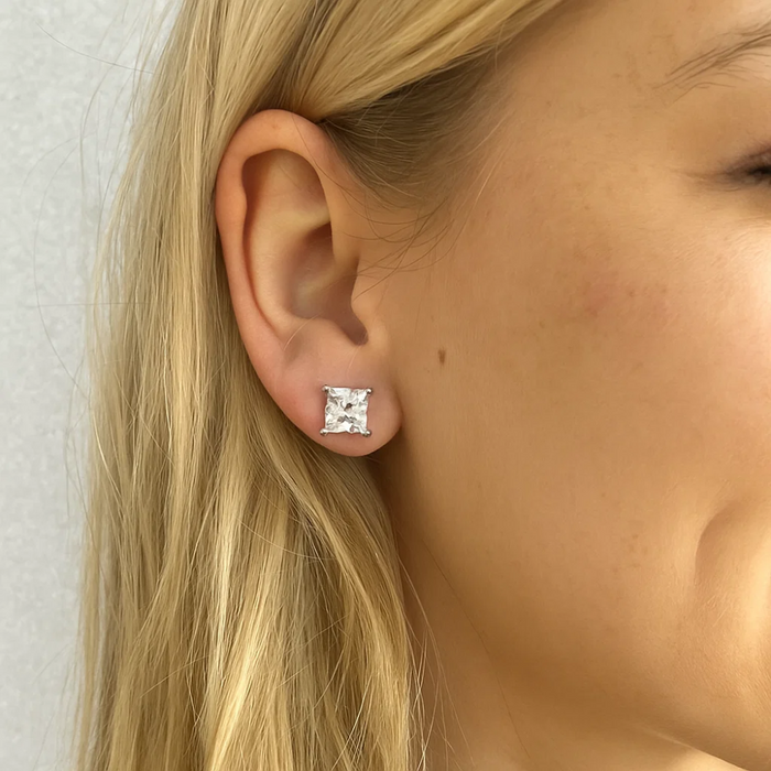 Close-up of one princess-cut cubic zirconia stud earring on ear