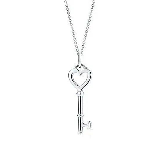 Heart-shaped charm and key pendant necklace on a silver-tone chain