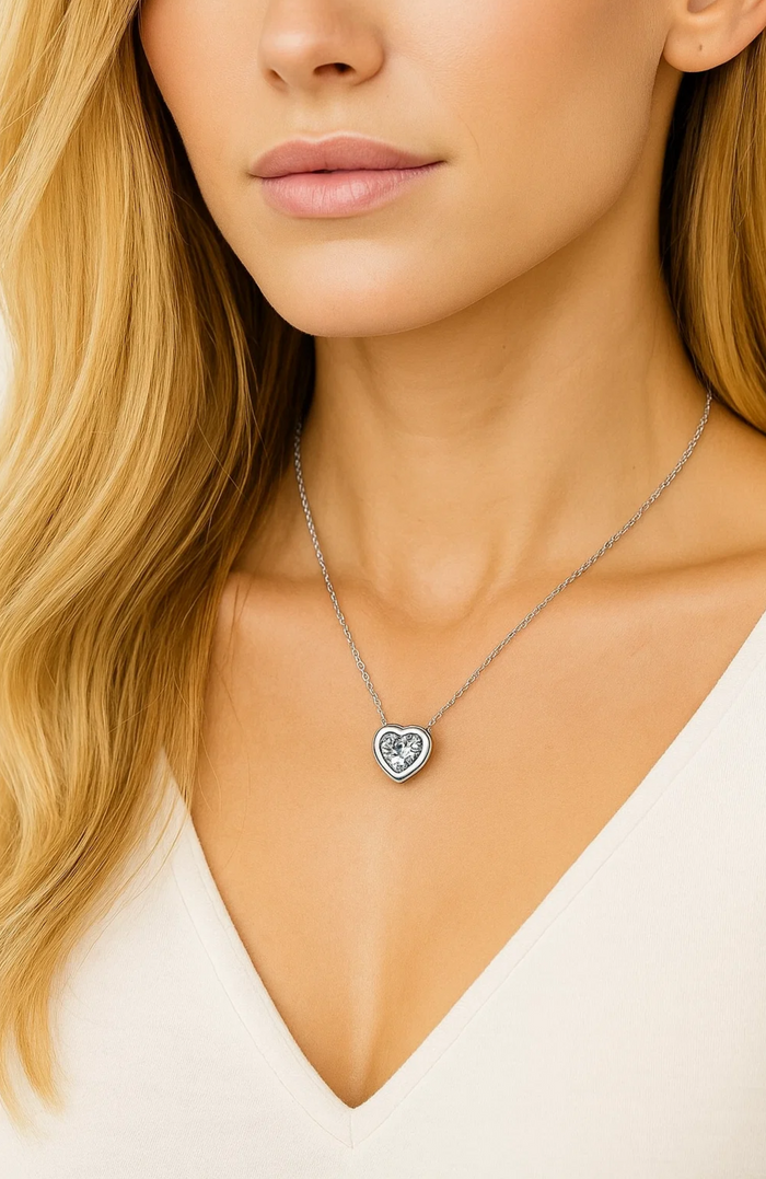 Silver-tone heart pendant necklace with clear cubic zirconia crystal, close-up view