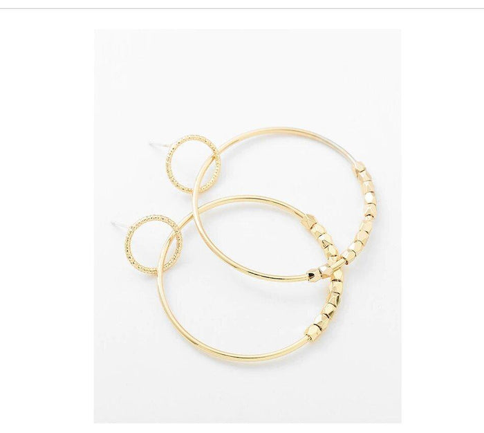 Gold hoop dangle earrings close-up of stacked hoops and bead-link chain