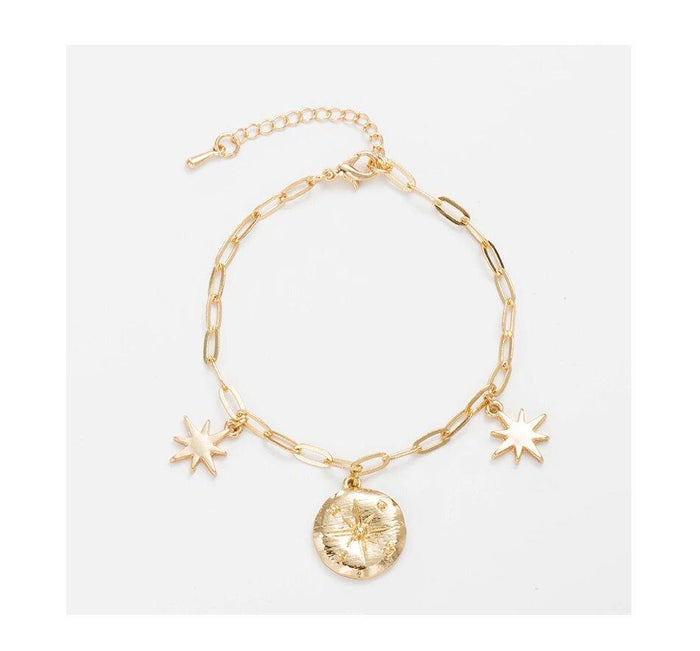 Gold-tone link charm bracelet with star charms and round locket pendant