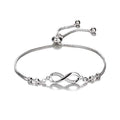 Silver infinity bracelet with adjustable chain and small crystal accents