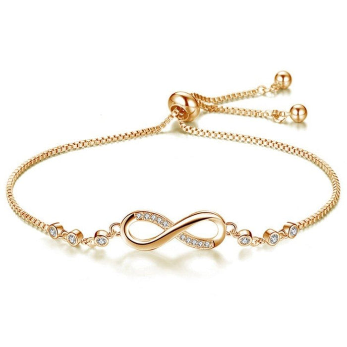 Gold infinity bracelet with crystal accents and adjustable chain