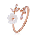 Rose gold cherry blossom ring with white flower and marquise-cut stones