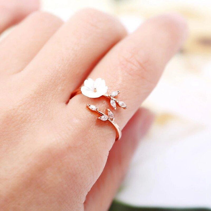 Rose gold cherry blossom ring with white flower and delicate branch details