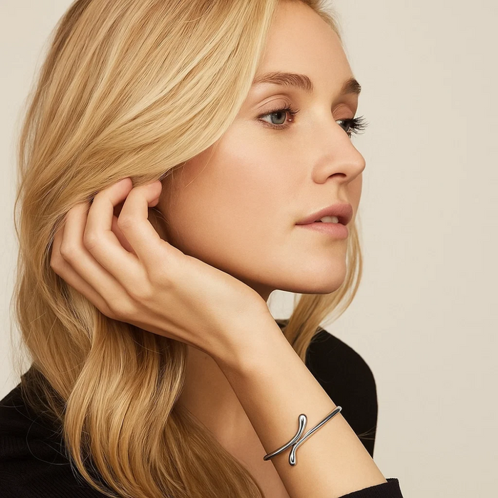 Gold teardrop open wrap bangle bracelet worn on wrist, slim open design