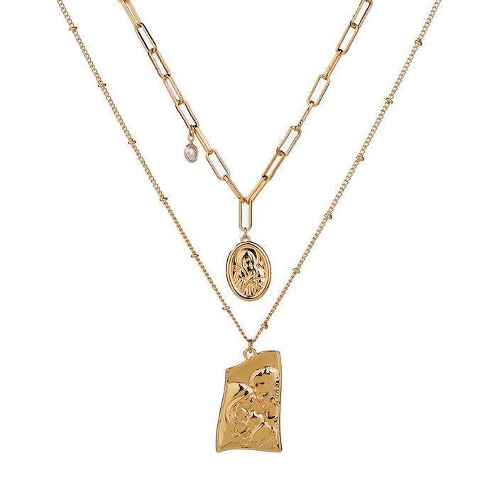 Gold layered necklace with Jesus pendant and round medallion, linked chain.