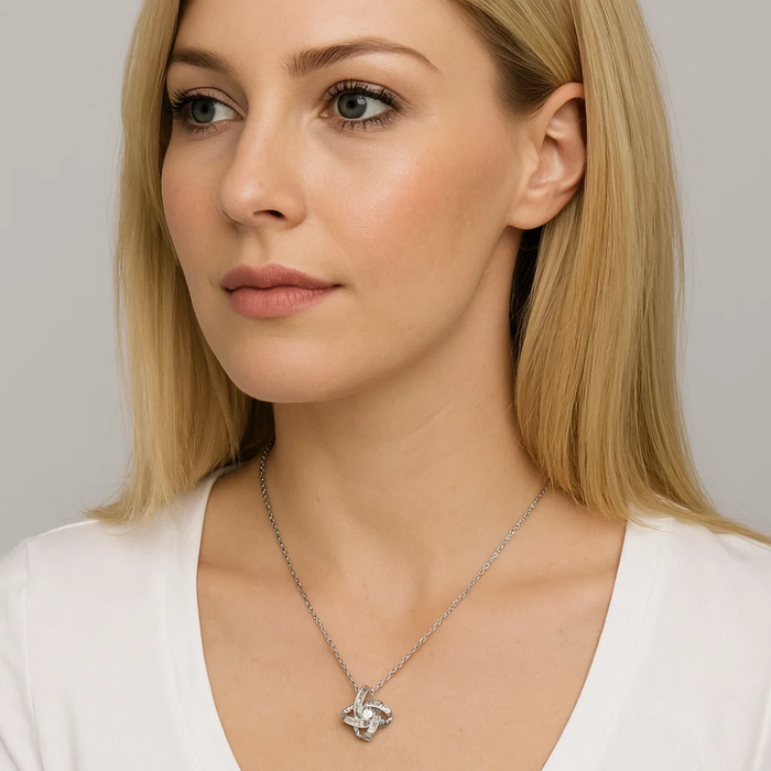 Silver knot pendant necklace with cubic zirconia centerpiece on link chain