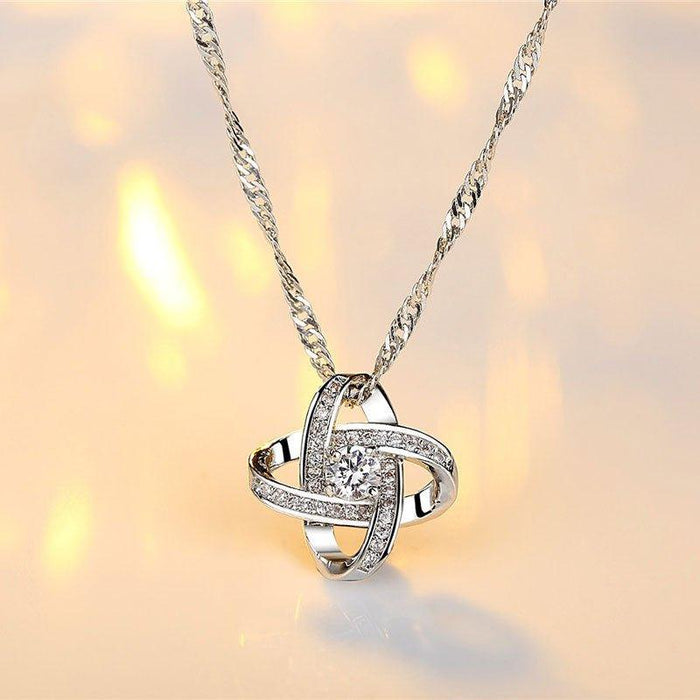 Silver knot pendant necklace with cubic zirconia settings and link chain