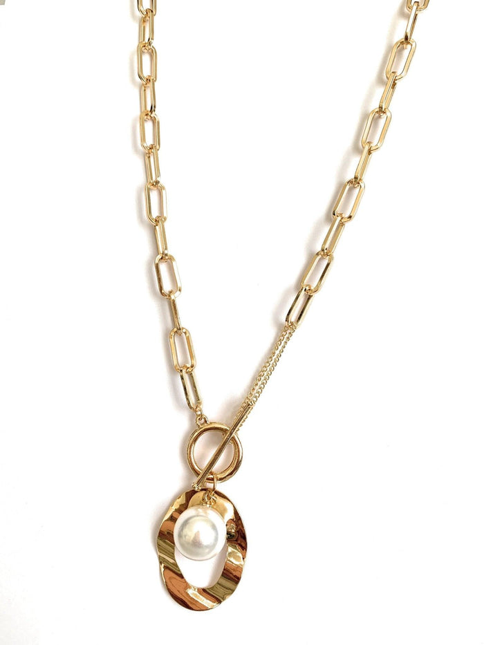 Gold link necklace with oval pendant, faux pearl, and dangling loop detail