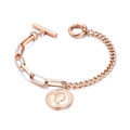 Rose gold link bracelet with round coin charm, curb chain and toggle clasp