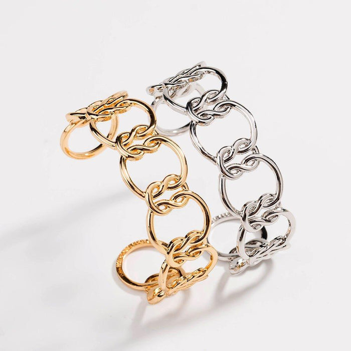 Two-tone love-knot link bracelet with gold and silver chain links interwoven