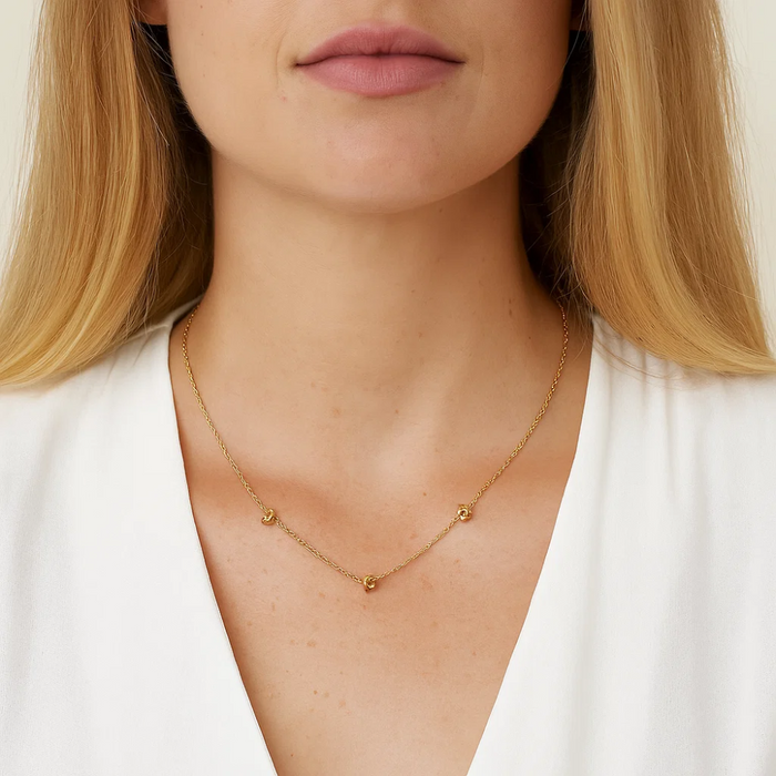 Gold-tone chain necklace with double love-knot charm links